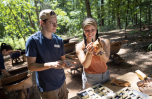 Archaeology interns Adam Shinberg (left) and Kaira Otero (right) studying artifacts at Monticello- UVA Archaeological Field School in Charlottesville, VA. Photo by Parker Michels-Boyce.